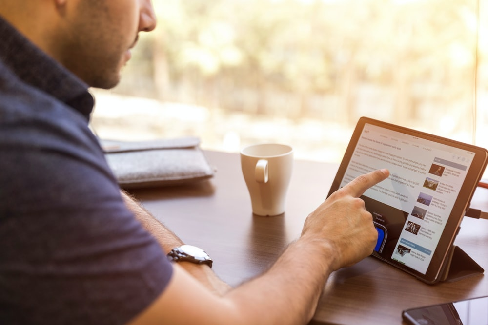 A man reading from a laptop screen