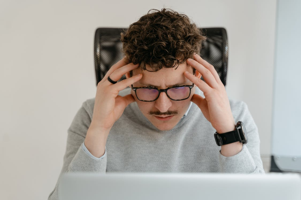 A frustrated job seeker staring at a laptop screen